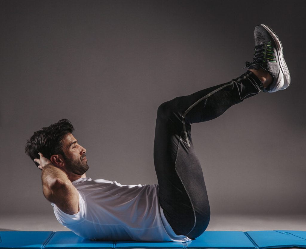A man doing crunches with upward legs